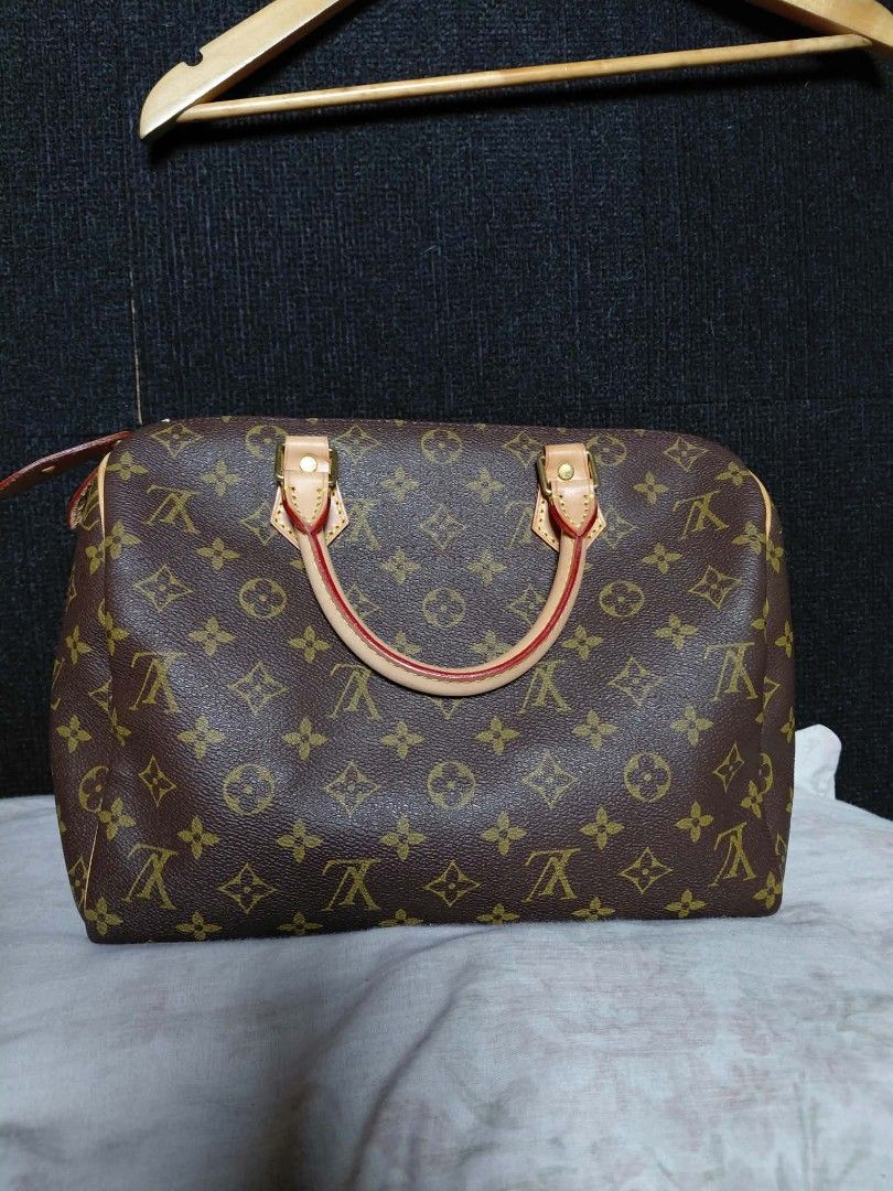 Louis Vuitton Monogram Canvas Speedy Handbag (Category: Luxury Bags & Wallets) located in Baguio. Submitted by angeloshoppebaguio2600 (Listing ID 1468133003, Image 1). Description: - Louis Vuitton with classic Monogram canvas pattern - Vachetta leather handles and trim with signature yellow stitching - Shiny gold-tone hardware stamped with Louis Vuitton - Secure zipper closure with leather pull tab - Clean brown textile lining inside - RUSH SALE 