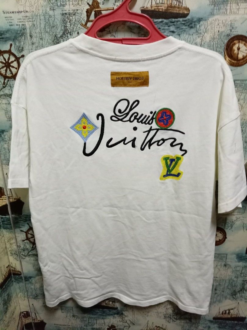 Louis Vuitton White T-Shirt Size S (Category: Shirts) located in Baguio. Submitted by jnjayceelbrn (Listing ID 1468172888, Image 2). Description: - Brand: Louis Vuitton - Item: White Crewneck T-Shirt - Size: Small (S tag attached) - Design: Colorful embroidered graphics on the front chest and statement design with signature script lettering on the back - Material: Premium cotton, relaxed fit - Origin: Made in Italy.