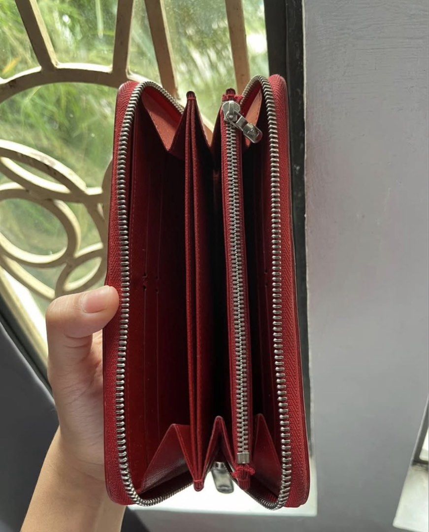 red wallet (Category: Luxury Bags & Wallets) located in Manila. Submitted by liz_1994 (Listing ID 1468082807, Image 2). Description: - Brand: Louis Vuitton - Model: Zippy Wallet (M60304) - Material: Epi Leather - Color: Carmin Red - Hardware: Silver-tone - Closure: Zip-around - Interior: Multiple card slots, bill compartments, and zippered coin pocket .