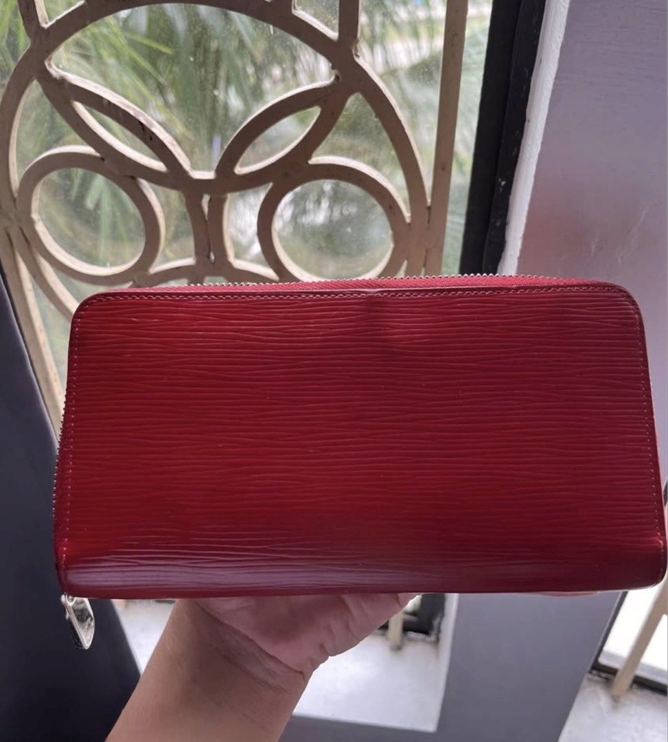 red wallet (Category: Luxury Bags & Wallets) located in Manila. Submitted by liz_1994 (Listing ID 1468082807, Image 3). Description: - Brand: Louis Vuitton - Model: Zippy Wallet (M60304) - Material: Epi Leather - Color: Carmin Red - Hardware: Silver-tone - Closure: Zip-around - Interior: Multiple card slots, bill compartments, and zippered coin pocket .