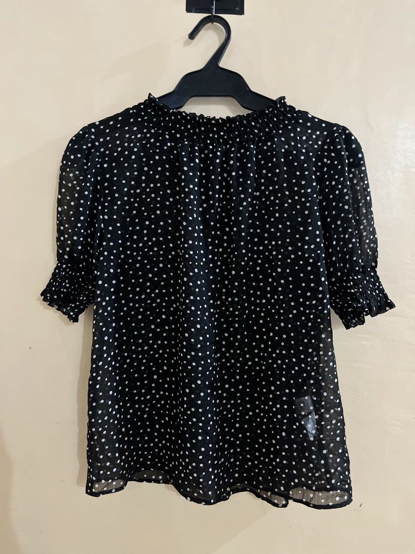 LOWRYS FARM Polka Dot Priere Blouse 798918 (Category: Blouses) located in Binan City. Submitted by hannahbanana928 (Listing ID 1468202599, Image 2). Description: - Brand: LOWRYS FARM - Design: Classic black with white polka dots - Details: Sheer lightweight fabric, short puff sleeves, ruffled neckline and cuffs, smocked detailing - Styling: Breezy and easy to pair with trousers or skirts - Occasion: Perfect for casual days or work outfits - Condi