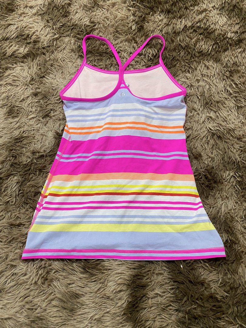 Lululemon Athletic Striped Tank Top Size 8 (Category: Sleeveless) located in Cagayan de Oro. Submitted by sepamorash53558 (Listing ID 1468264301, Image 2). Description: - Brand: Lululemon - Size: 8 (tag attached) - Design: Multi-color striped pattern with lavender blue base and bright pink straps - Features: Racerback style with built-in shelf bra lining and signature silver logo on back hem - Material: Premium polyester and nylon blend - Care: M