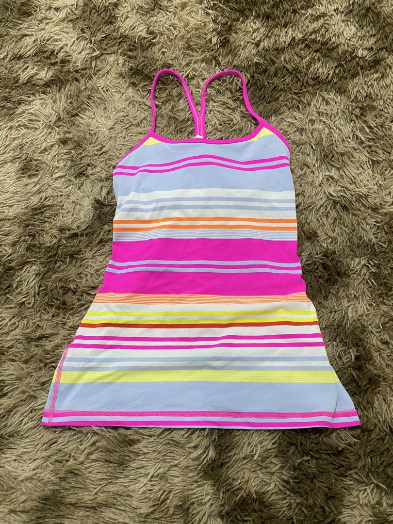 Lululemon Athletic Striped Tank Top Size 8 (Category: Sleeveless) located in Cagayan de Oro. Submitted by sepamorash53558 (Listing ID 1468264301, Image 1). Description: - Brand: Lululemon - Size: 8 (tag attached) - Design: Multi-color striped pattern with lavender blue base and bright pink straps - Features: Racerback style with built-in shelf bra lining and signature silver logo on back hem - Material: Premium polyester and nylon blend - Care: M