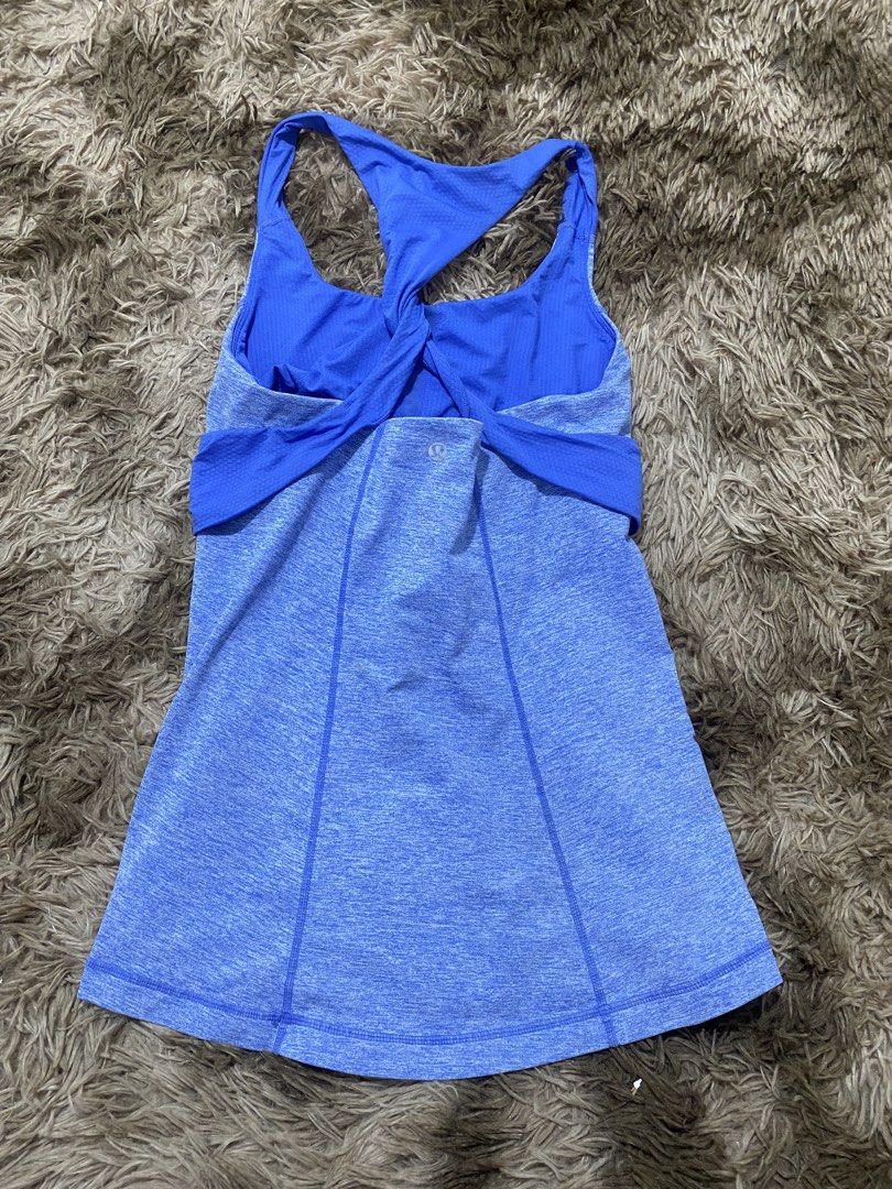 Lululemon Blue Heathered Tank Top Size 8 (Category: Sleeveless) located in Cagayan de Oro. Submitted by sepamorash53558 (Listing ID 1468197751, Image 2). Description: - Brand: Lululemon - Size: 8 - Color: Heathered blue with royal blue twist-back straps - Support: Built-in bra included - Design: Flattering curved hem with side ruching details and iconic silver reflective logo near upper back - Ideal for: Running, yoga, and gym workouts - Conditio
