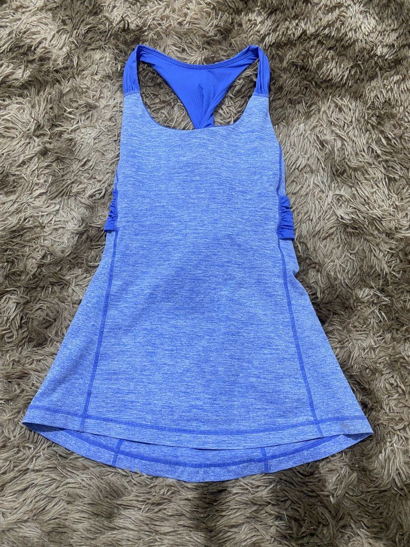 Lululemon Blue Heathered Tank Top Size 8 (Category: Sleeveless) located in Cagayan de Oro. Submitted by sepamorash53558 (Listing ID 1468197751, Image 1). Description: - Brand: Lululemon - Size: 8 - Color: Heathered blue with royal blue twist-back straps - Support: Built-in bra included - Design: Flattering curved hem with side ruching details and iconic silver reflective logo near upper back - Ideal for: Running, yoga, and gym workouts - Conditio