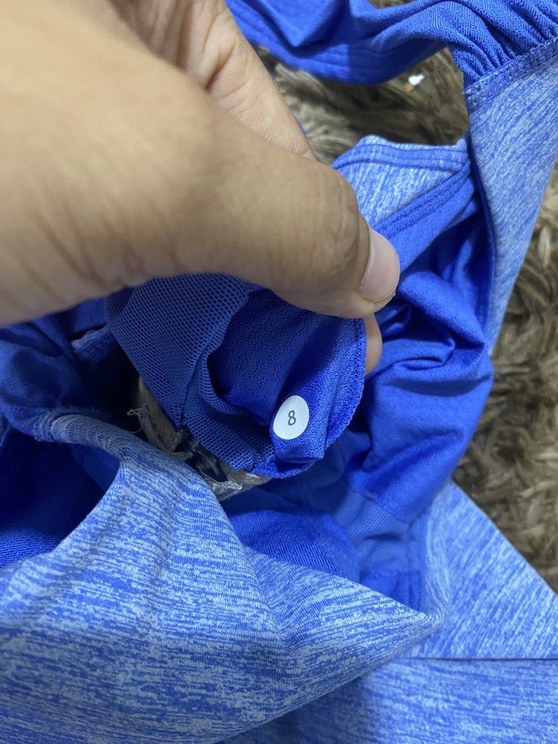 Lululemon Blue Heathered Tank Top Size 8 (Category: Sleeveless) located in Cagayan de Oro. Submitted by sepamorash53558 (Listing ID 1468197751, Image 3). Description: - Brand: Lululemon - Size: 8 - Color: Heathered blue with royal blue twist-back straps - Support: Built-in bra included - Design: Flattering curved hem with side ruching details and iconic silver reflective logo near upper back - Ideal for: Running, yoga, and gym workouts - Conditio