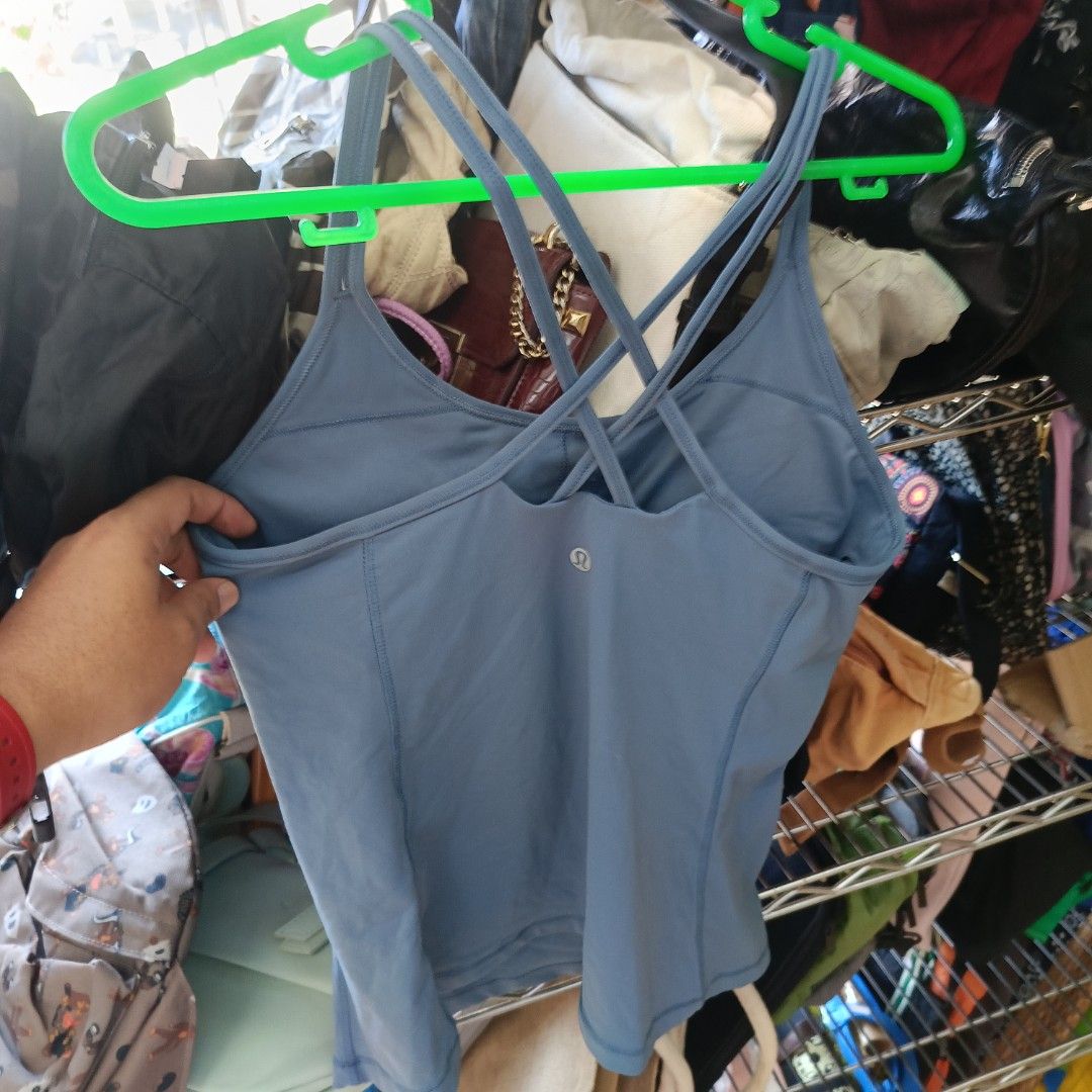 Lululemon Blue Strappy Back Tank Top Size 8 (Category: Activewear) located in San Jose del Monte. Submitted by qu4litees (Listing ID 1468071009, Image 1). Description: - Brand: Lululemon - Color: Dusty Blue - Size: 8 (tag attached) - Features: Built-in bra lining with removable cup slots, strappy criss-cross back design, and signature reflective logo - Material: Smooth and stretchy athletic fabric (Made in Vietnam).