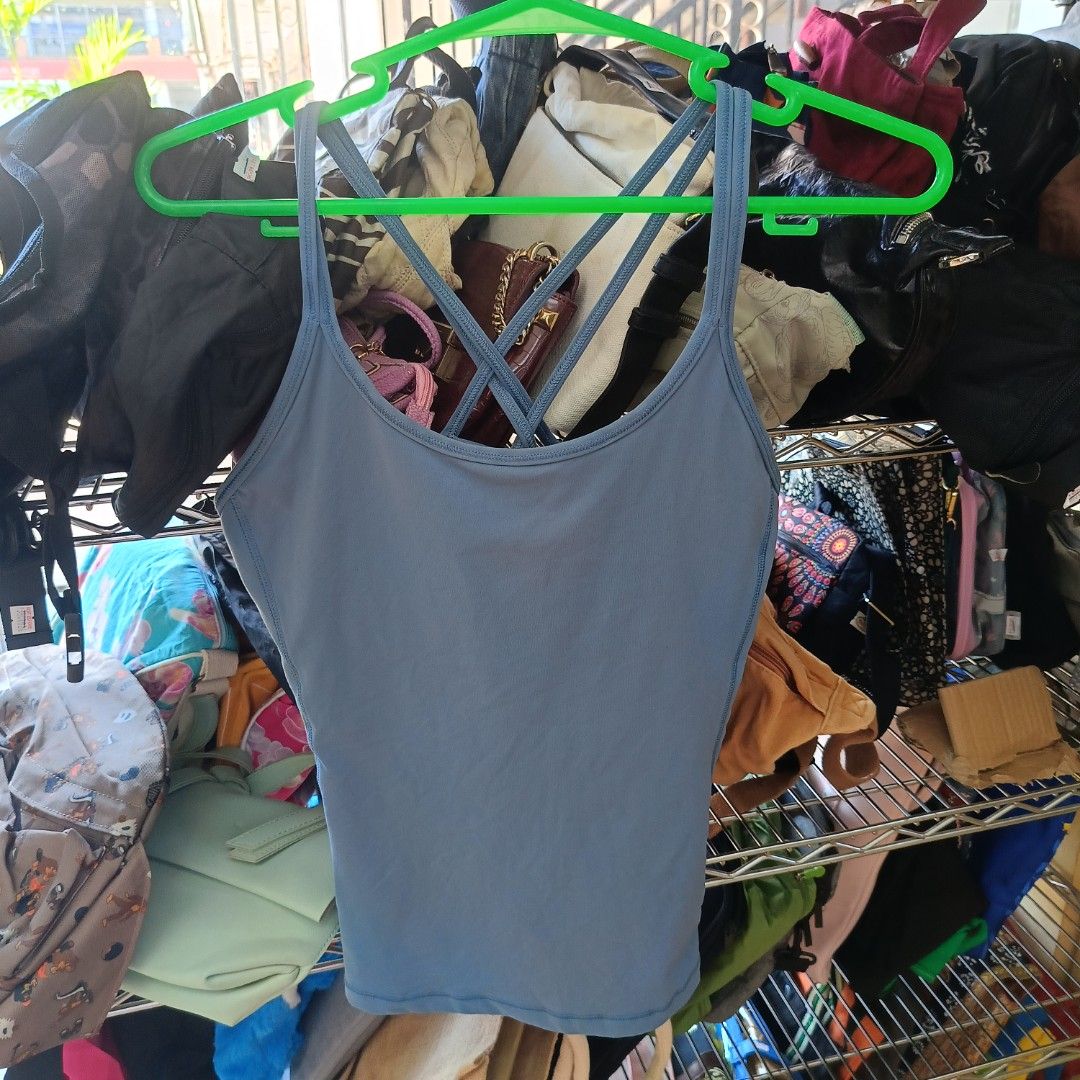 Lululemon Blue Strappy Back Tank Top Size 8 (Category: Activewear) located in San Jose del Monte. Submitted by qu4litees (Listing ID 1468071009, Image 2). Description: - Brand: Lululemon - Color: Dusty Blue - Size: 8 (tag attached) - Features: Built-in bra lining with removable cup slots, strappy criss-cross back design, and signature reflective logo - Material: Smooth and stretchy athletic fabric (Made in Vietnam).