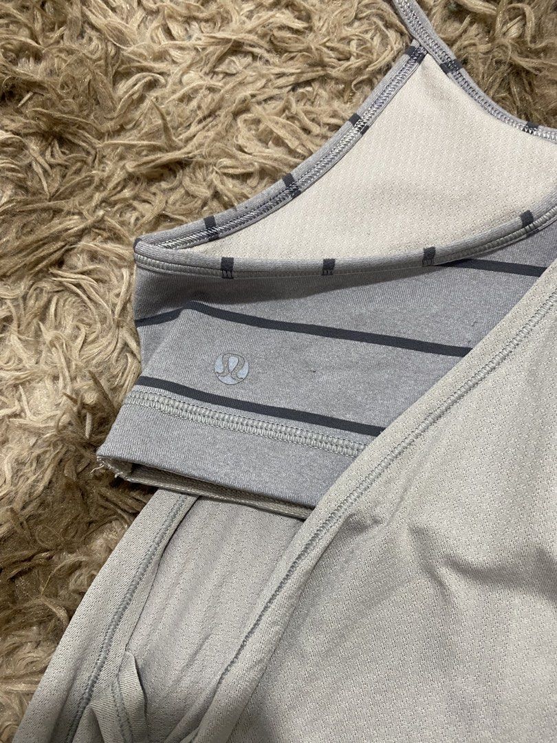 Lululemon Grey Built-In Bra Tank Top Size 10 (Category: Sleeveless) located in Cagayan de Oro. Submitted by sepamorash53558 (Listing ID 1468264309, Image 3). Description: - Brand: Lululemon - Size: 10 (tag attached) - Color: Light Grey with striped built-in sports bra - Design: Racerback, flowy gathered body with fitted bottom hem, and classic logo on lower side - Condition: Great workout piece, airy and easy to move in.