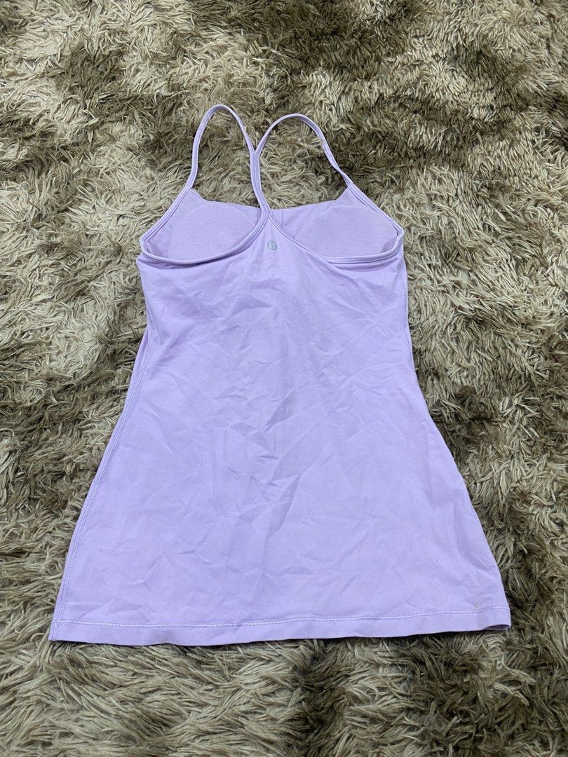 Lululemon Light Purple Tank Top Size 6 (Category: Sleeveless) located in Cagayan de Oro. Submitted by sepamorash53558 (Listing ID 1468264307, Image 2). Description: - Brand: Lululemon - Color: Light purple - Size: 6 (tag located inside the bra pocket) - Features: Built-in shelf bra, strappy racerback design, silver logo on the back - Condition: Pre-loved with a small brownish stain near the logo on the lower back area.