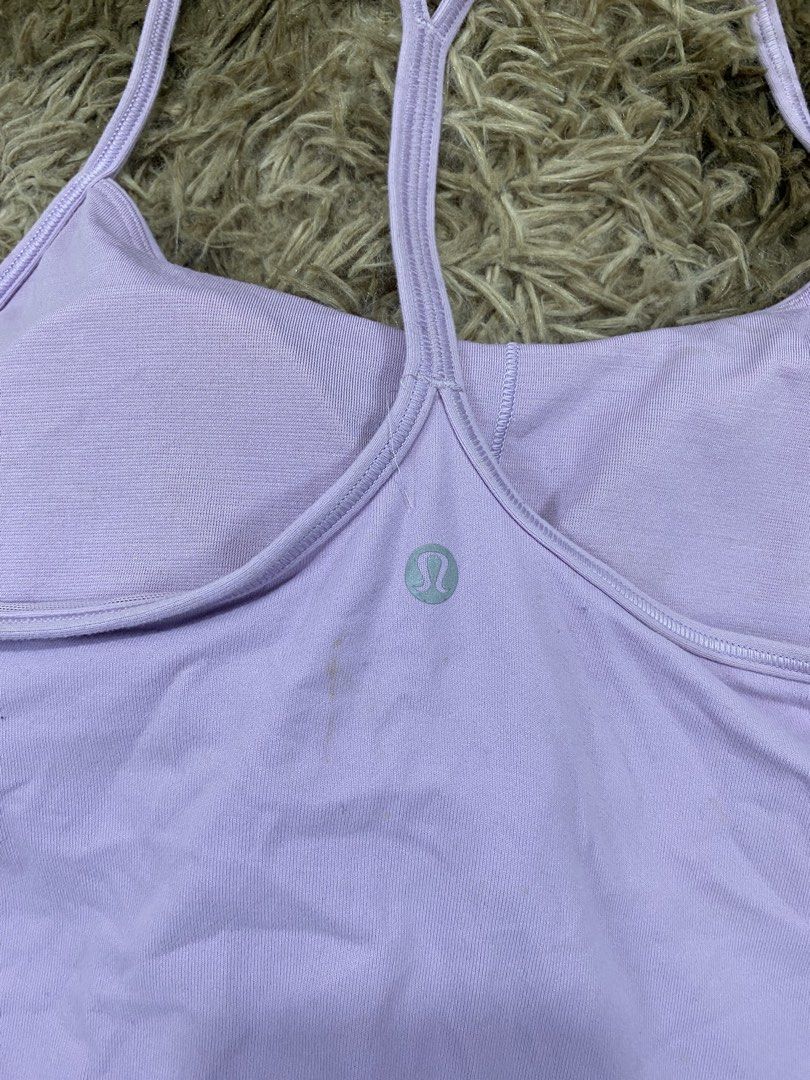 Lululemon Light Purple Tank Top Size 6 (Category: Sleeveless) located in Cagayan de Oro. Submitted by sepamorash53558 (Listing ID 1468264307, Image 3). Description: - Brand: Lululemon - Color: Light purple - Size: 6 (tag located inside the bra pocket) - Features: Built-in shelf bra, strappy racerback design, silver logo on the back - Condition: Pre-loved with a small brownish stain near the logo on the lower back area.