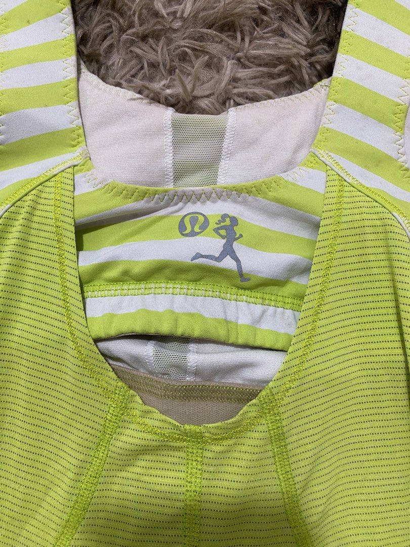 Lululemon Lime Green Striped Tank Top Size 4 (Category: Sleeveless) located in Cagayan de Oro. Submitted by sepamorash53558 (Listing ID 1468264277, Image 3). Description: - Brand: Lululemon - Size: 4 (dot tag inside cup pocket) - Color: Bright lime green with white and green striped straps - Features: Built-in shelf bra, cinched back detail, and iconic running logo on the back - Material: Lightweight ribbed fabric - Ideal for: Running, yoga, gym 