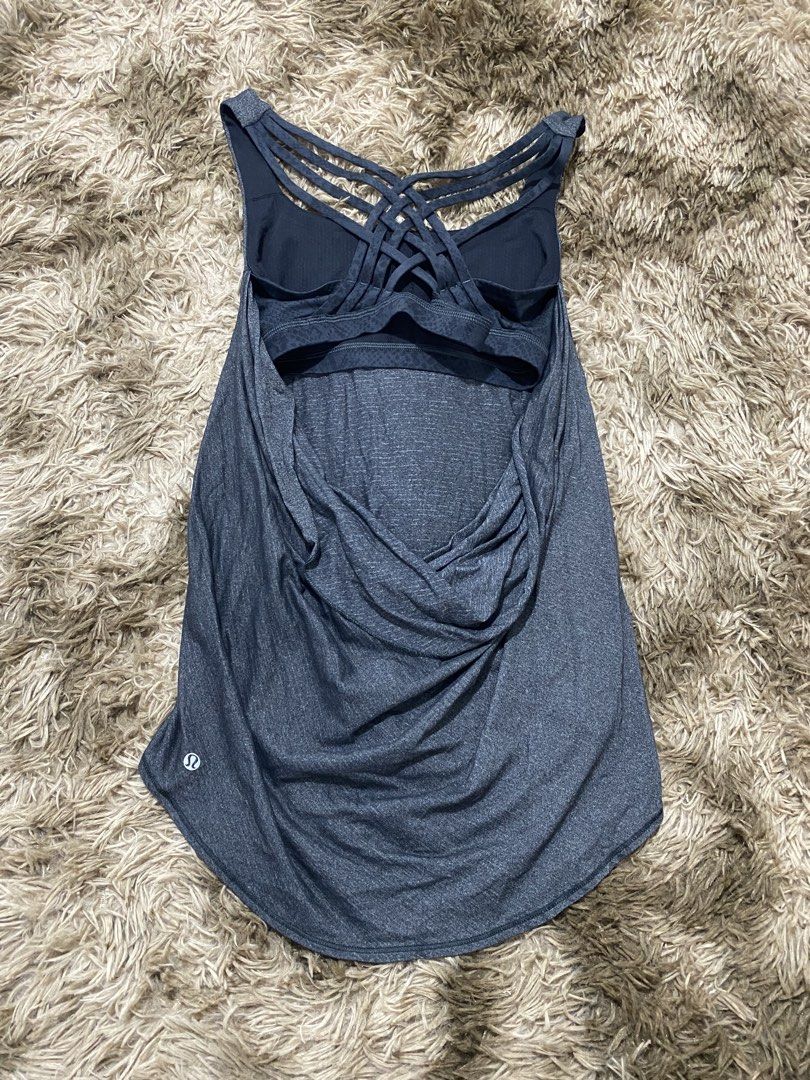 Lululemon Strappy Back Tank Top Grey Size 8 (Category: Sleeveless) located in Cagayan de Oro. Submitted by sepamorash53558 (Listing ID 1468264312, Image 2). Description: - Authentic Lululemon workout tank top - Color: Dark Grey Heather - Built-in bra with removable pads included - Stunning multi-strap criss-cross back design - Curved hem with extra length in the back for coverage - Signature reflective silver Lululemon logo near hem - Size dot ve