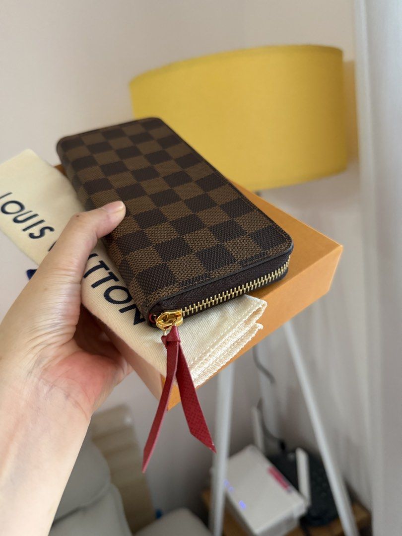 LV WALLET CLEMENCE- Damier (Category: Wallets & Card holders) located in Makati City. Submitted by lambogirl (Listing ID 1468189442, Image 1). Description: ✔️The image shows a Louis Vuitton Clémence Wallet in the Damier Ébène canvas with a cherry-red leather zipper pull. ✔️comes complete ✔️free shipping or pick up (Makati).