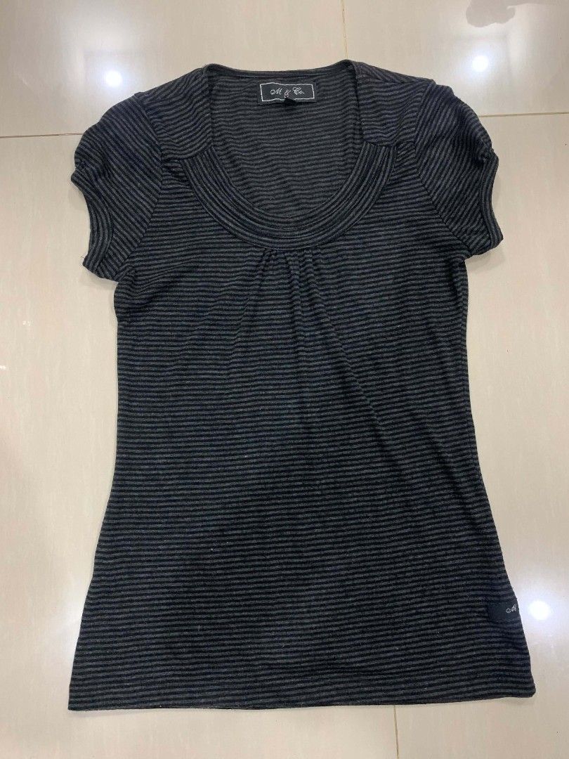 M & Co Striped Short Sleeve Top (Category: Shirts) located in Tiaong. Submitted by cdoswan (Listing ID 1468204266, Image 1). Description: - Brand: M & Co. - Color: Black and grey stripes - Style: Short sleeve top with fitted silhouette - Neckline: Scoop neck with front gathered pleats - Details: Ribbed collar and trim, small branded hem tag - Material: Soft stretch knit - Condition: Great casual everyday basic.