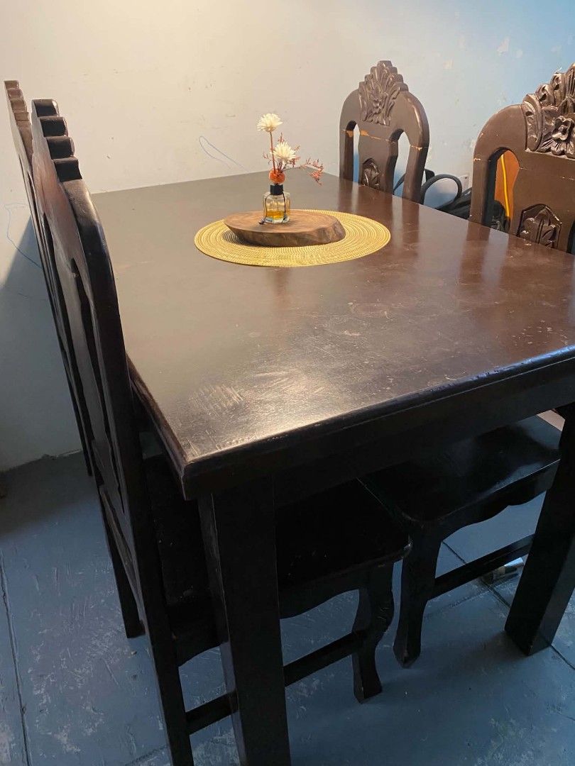 Mahogany Solid Wood Dining Table with 4 Carved Chairs (Category: Tables & Sets) located in San Fernando. Submitted by zobelgeorgieee (Listing ID 1468062293, Image 3). Description: - Set includes: 1 solid dark wood dining table and 4 matching chairs - Features: Intricate carved details on chair backs and a sturdy, heavy build - Condition: Surface scratches and wear on tabletop from daily family meals (adds to rustic charm or perfect for refinishin