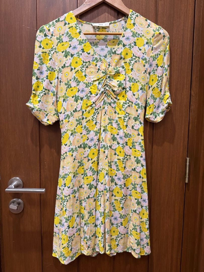 Mango Floral V-Neck A-Line Dress (Category: Dresses) located in Makati City. Submitted by gobernice (Listing ID 1468117401, Image 2). Description: - Brand: Mango - Style: Off White & Yellow floral print dress with V-neckline and ruched front detail - Size: EUR XS / USA 2 - Features: Short sleeves, concealed side zipper, lightweight fabric - Condition: Used once, clean and well maintained - Perfect for: Casual days out, weekend brunches, and sunny