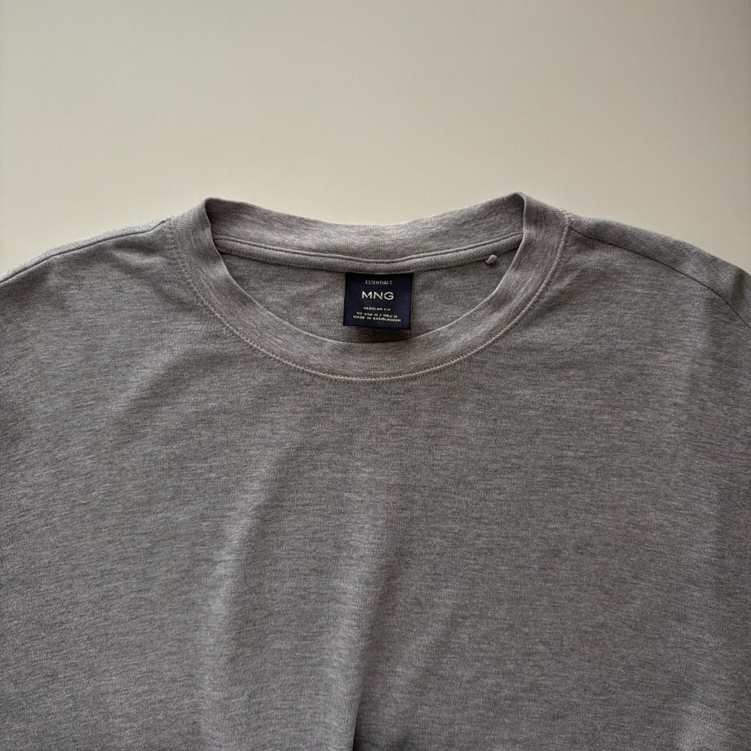 Mango Man Regular Fit Gray T-shirt (Category: Tshirts & Polo Shirts ) located in Cebu City. Submitted by hommeboy.howard (Listing ID 1468243167, Image 3). Description: - Color: Solid grey heather - Material: Soft, comfortable cotton - Fit: Regular fit with classic crew neck and short sleeves - Versatile: Easy to match with any outfit - Condition: Clean, well-maintained piece, perfect for everyday wear Loc: Cebu City Shipping fee c/o buyer.