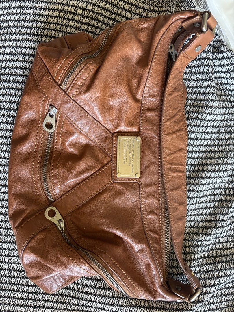 Marc by Marc Jacobs Brown Leather Shoulder Bag (Category: Luxury Bags & Wallets) located in Manila. Submitted by loislane112233 (Listing ID 1468081872, Image 1). Description: - Authentic Marc by Marc Jacobs leather shoulder bag in rich brown - Crafted from supple, textured leather with stylish stitched panel details - Secure zip closures on both the main compartment and front pockets - Sleek silver-tone hardware accented with a front metal logo p