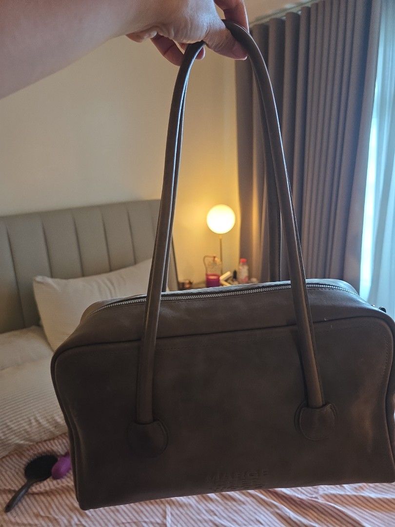 Marge Sherwood Boston Taupe (Category: Shoulder Bags) located in Taguig. Submitted by variegatedmuseph (Listing ID 1468138052, Image 1). Description: - Brand: Marge Sherwood (Authentic) - Color: Dark Brown - Design: Structured rectangular shape with subtle vertical embossed logo - Straps: Long twin shoulder straps for comfortable wear - Closure: Secure zip top closure running along the side - Usage: Spacious and stylish, perfect for daily carry R