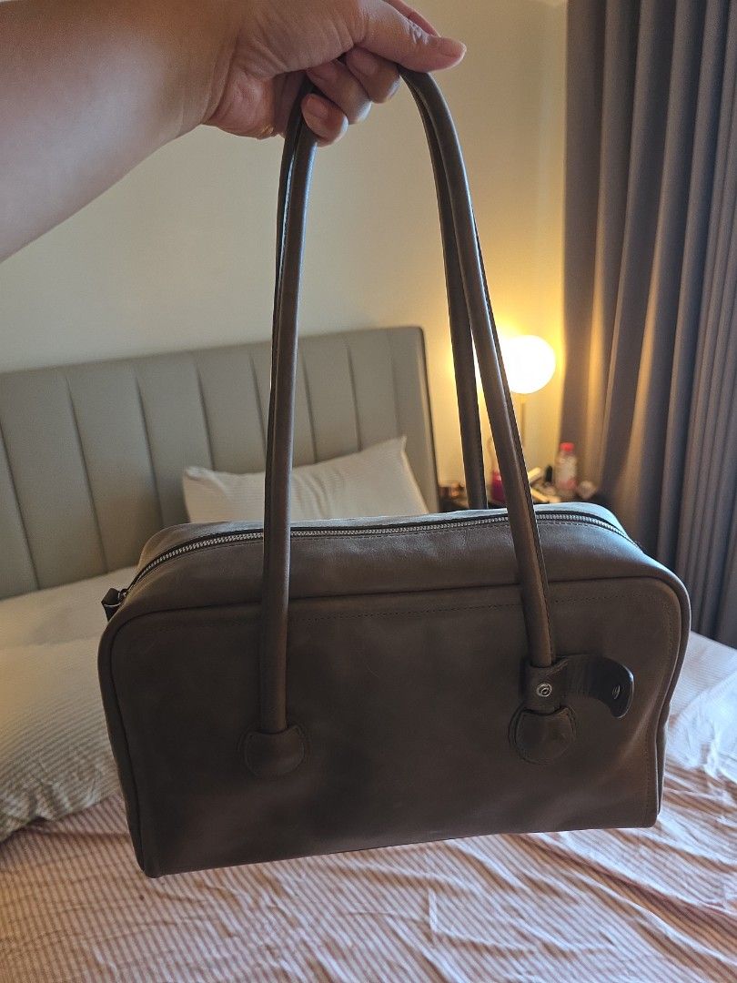 Marge Sherwood Boston Taupe (Category: Shoulder Bags) located in Taguig. Submitted by variegatedmuseph (Listing ID 1468138052, Image 3). Description: - Brand: Marge Sherwood (Authentic) - Color: Dark Brown - Design: Structured rectangular shape with subtle vertical embossed logo - Straps: Long twin shoulder straps for comfortable wear - Closure: Secure zip top closure running along the side - Usage: Spacious and stylish, perfect for daily carry R