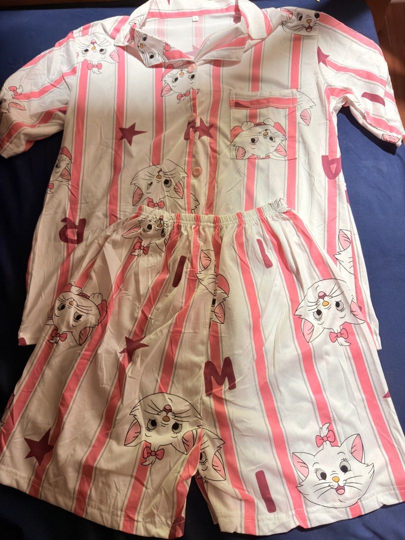 Marie Cat Pink Striped Pajama Set (Category: Undergarments & Loungewear) located in Manila. Submitted by badassjowie (Listing ID 1468068734, Image 1). Description: - Adorable pink and white striped design featuring Marie the cat prints, stars, and fun lettering - Short-sleeve button-down top complete with a chic collar and chest pocket - Matching shorts equipped with a comfortable elastic waistband - Crafted from ultra-soft and breathable fabric 