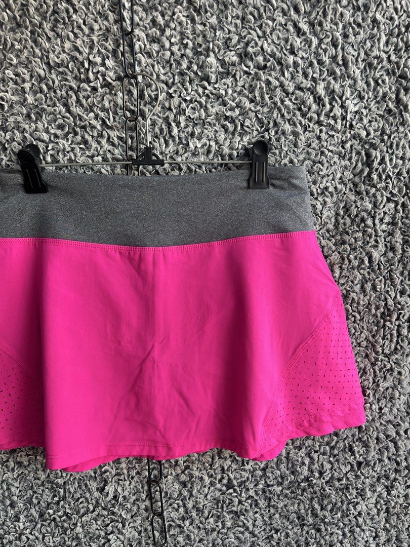 Marika athletic athletic skort | Size M (Category: Skirts) located in General Trias. Submitted by zrchustle.604 (Listing ID 1468280999, Image 3). Description: Marika athletic athletic skort featuring a vibrant fuchsia pink body with laser-cut perforation details for ventilation, paired with a heather gray elastic waistband. The back of the waistband includes a subtle Marika logo emblem along with a small zip storage pocket..