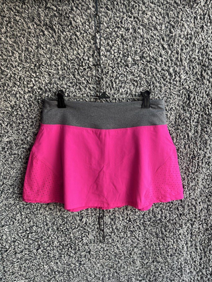 Marika athletic athletic skort | Size M (Category: Skirts) located in General Trias. Submitted by zrchustle.604 (Listing ID 1468280999, Image 2). Description: Marika athletic athletic skort featuring a vibrant fuchsia pink body with laser-cut perforation details for ventilation, paired with a heather gray elastic waistband. The back of the waistband includes a subtle Marika logo emblem along with a small zip storage pocket..
