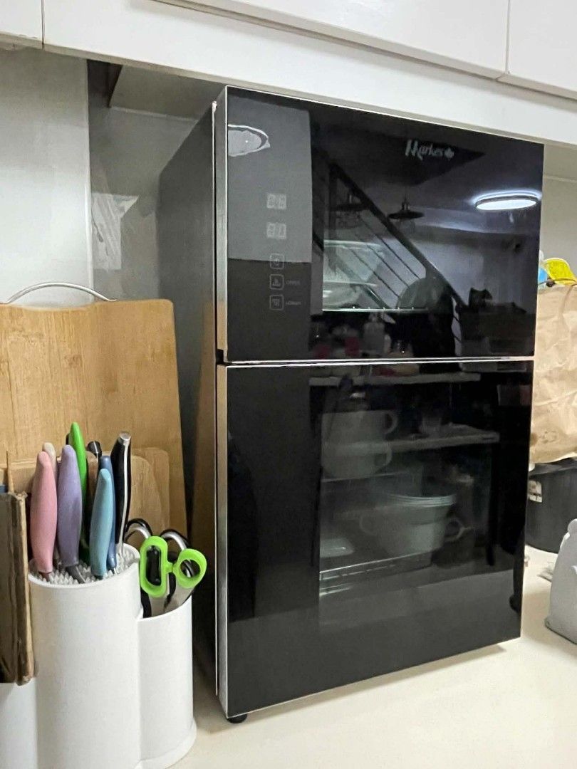 Markes Double Door Kitchen Dish Sterilizer Cabinet (Category: Dishwasher) located in Manila. Submitted by royalowl_34d849 (Listing ID 1468174813, Image 1). Description: - Brand: Markes - Color/Finish: Sleek black with clean glass doors - Control: Digital control panel on the top door - Interior: Two separate compartments with wire racks for plates, bowls, and mugs - Function: Sanitizes and organizes kitchenware on your countertop - Power: Plug-in