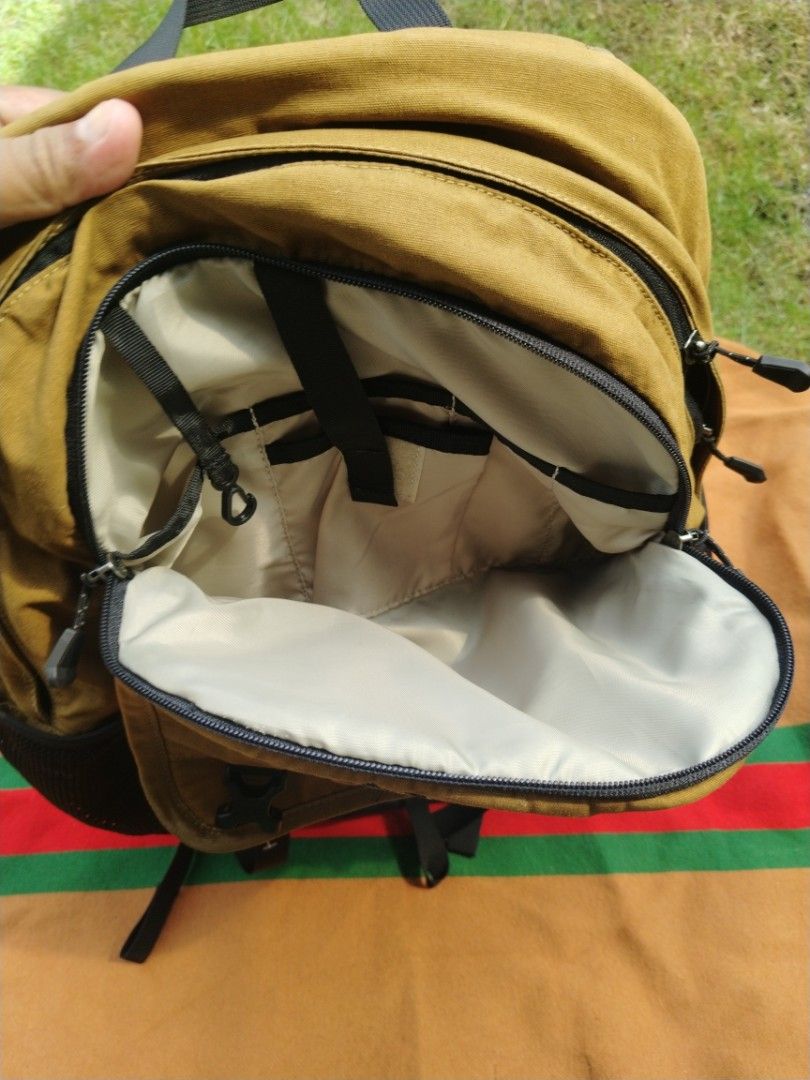 Marmot Mountain Empire Backpack (Category: Backpacks) located in Legazpi City. Submitted by genobecollectives (Listing ID 1468080768, Image 3). Description: - Brand: Marmot Mountain Empire - Color: Mustard Yellow and Black - Design: Front flap with dual buckle straps - Storage: Multiple zippered compartments, interior organizers, and a dedicated laptop sleeve - Pockets: Convenient mesh side pockets - Comfort: Padded back panel and shoulder straps