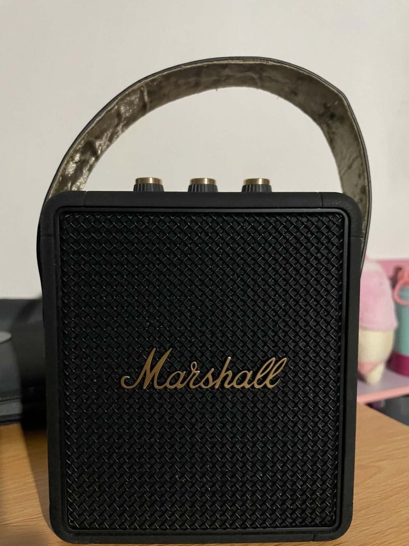 Marshall Stockwell II Portable Bluetooth Speaker (Category: Soundbars, Speakers & Amplifiers) located in Quezon City. Submitted by johnlimboy (Listing ID 1468209319, Image 1). Description: - Authentic Marshall Stockwell II portable bluetooth speaker in classic black and gold - Features tactile top control dials for volume, bass, and treble adjustments - Iconic metal grille front with the classic Marshall script logo - Compact and lightweight desi