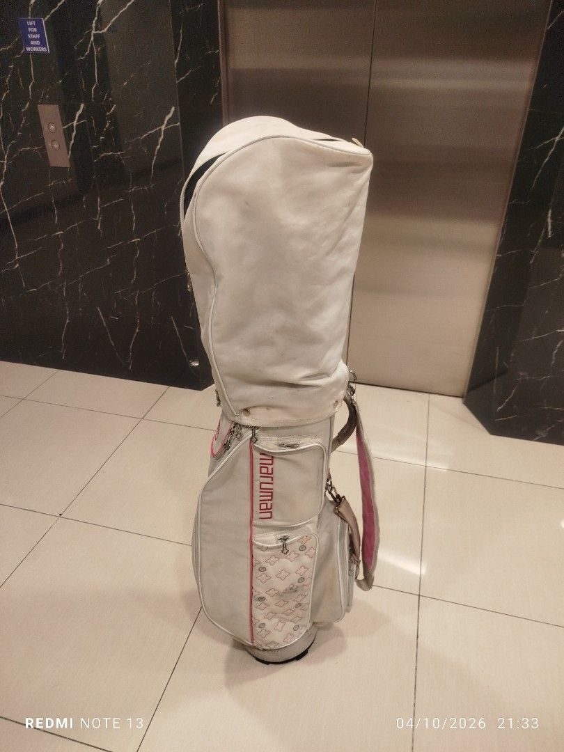 Maruman Golf Bag White Pink (Category: Golf) located in Taguig. Submitted by steve_doms (Listing ID 1468121759, Image 1). Description: - Brand: Maruman - Color: White with stylish pink accents - Storage: Multiple side pockets for all your gear - Protection: Includes upper cover with zipper closure - Stability: Structured base keeps the bag standing upright - Condition: Minor scuffs and marks on the white surface from previous use.