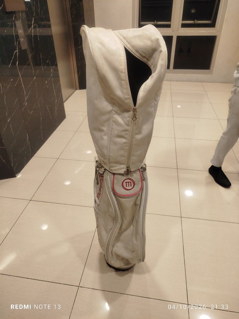 Maruman Golf Bag White Pink (Category: Golf) located in Taguig. Submitted by steve_doms (Listing ID 1468121759, Image 2). Description: - Brand: Maruman - Color: White with stylish pink accents - Storage: Multiple side pockets for all your gear - Protection: Includes upper cover with zipper closure - Stability: Structured base keeps the bag standing upright - Condition: Minor scuffs and marks on the white surface from previous use.