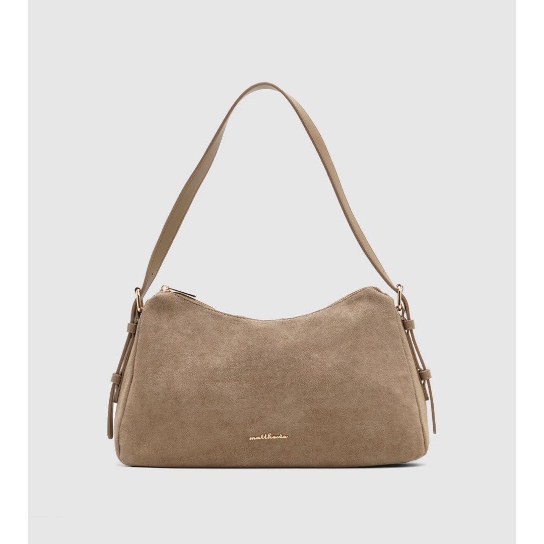 Matthews Venetia Shoulder Bag (Category: Shoulder Bags) located in Bulacan. Submitted by glnnsdclutter (Listing ID 1468254150, Image 1). Description: - Brand: Matthews Venetia - Color: Taupe - Material: Suede-texture panels with smooth sides - Closure & Interior: Secure top zipper with lined interior and extra pocket space - Fit: Clean shape with an easy drop for comfortable shoulder wear - Pricing: Original retail ₱1,999 / Store markdown ₱1,299 