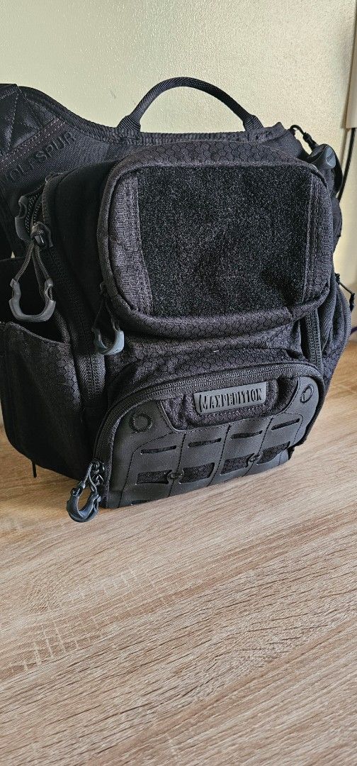 Maxpedition Wolfspur Tactical Crossbody Bag Black (Category: Sling Bags) located in Quezon City. Submitted by safeforest.492237 (Listing ID 1468232974, Image 1). Description: Maxpedition Wolfspur tactical bag in black. Heavy-duty construction with hexagonal ripstop fabric. Multiple zippered compartments and pockets for organizing gear. Molle webbing panel on front flap with Maxpedition logo tag. Velcro panel for patches. Padded mesh back panel an
