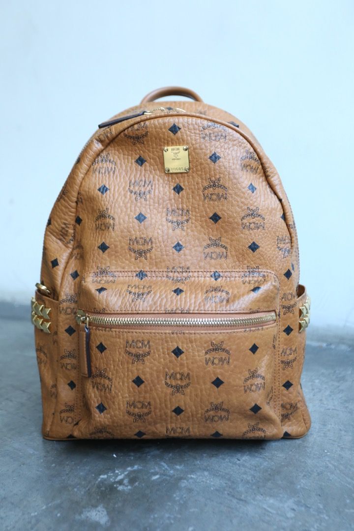 MCM - Stark Side Studs Visetos Backpack (Category: Luxury Bags & Wallets) located in Manila. Submitted by graymatter_ (Listing ID 1468144575, Image 3). Description: MCM - Stark Side Studs Visetos Backpack A pioneer in the realm of everyday luxury, the classic Stark backpack is sculpted from Visetos monogram canvas and nappa leather. Multi-faceted studs frame both sides of the silhouette, personifying the rebellious edge unique to MCM. Matching th