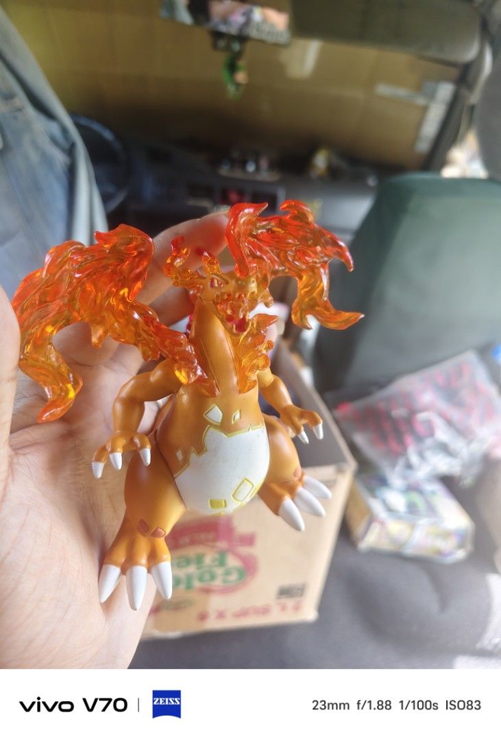 Mega Charizard X Pokemon Figure Transparent Flame Effect (Category: Figurines & Statues) located in Kapangan. Submitted by ClumZyDale (Listing ID 1468082540, Image 2). Description: - Mega Charizard X collectible figure - Striking orange and white body with bright translucent orange flame details on wings and back - Intricate claws and fierce facial expression - Durable, solid plastic build - Perfect display piece for Pokemon fans and collectors.