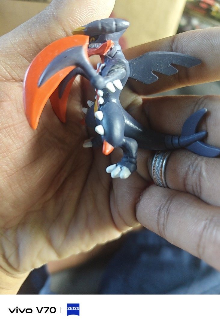 Mega Garchomp Pokémon Tomy Figure (Category: Figurines & Statues) located in Kapangan. Submitted by ClumZyDale (Listing ID 1468089265, Image 1). Description: - Authentic Tomy Pokémon miniature figure - Character: Mega Garchomp - Features iconic dark blue and orange color scheme - Official Pokémon and Tomy stamps located on the underside of the tail - Compact size, perfect for display or collection - Condition: Minor paint wear on the body.
