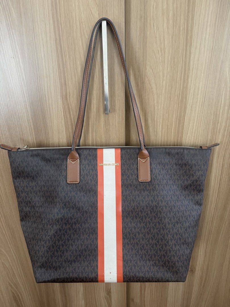 Michael Kors Bag (Category: Tote Bags) located in Manila. Submitted by prelovemd (Listing ID 1468102932, Image 1). Description: Large Travel bag from MK Authentic bag but no tags, no cc, paperbag Zoom in to see flaws and dirts / stains as shown on picture Cannot adjust the light but there are minimal chipped and dirt on the mid external lower front of the bag Zippers working well .