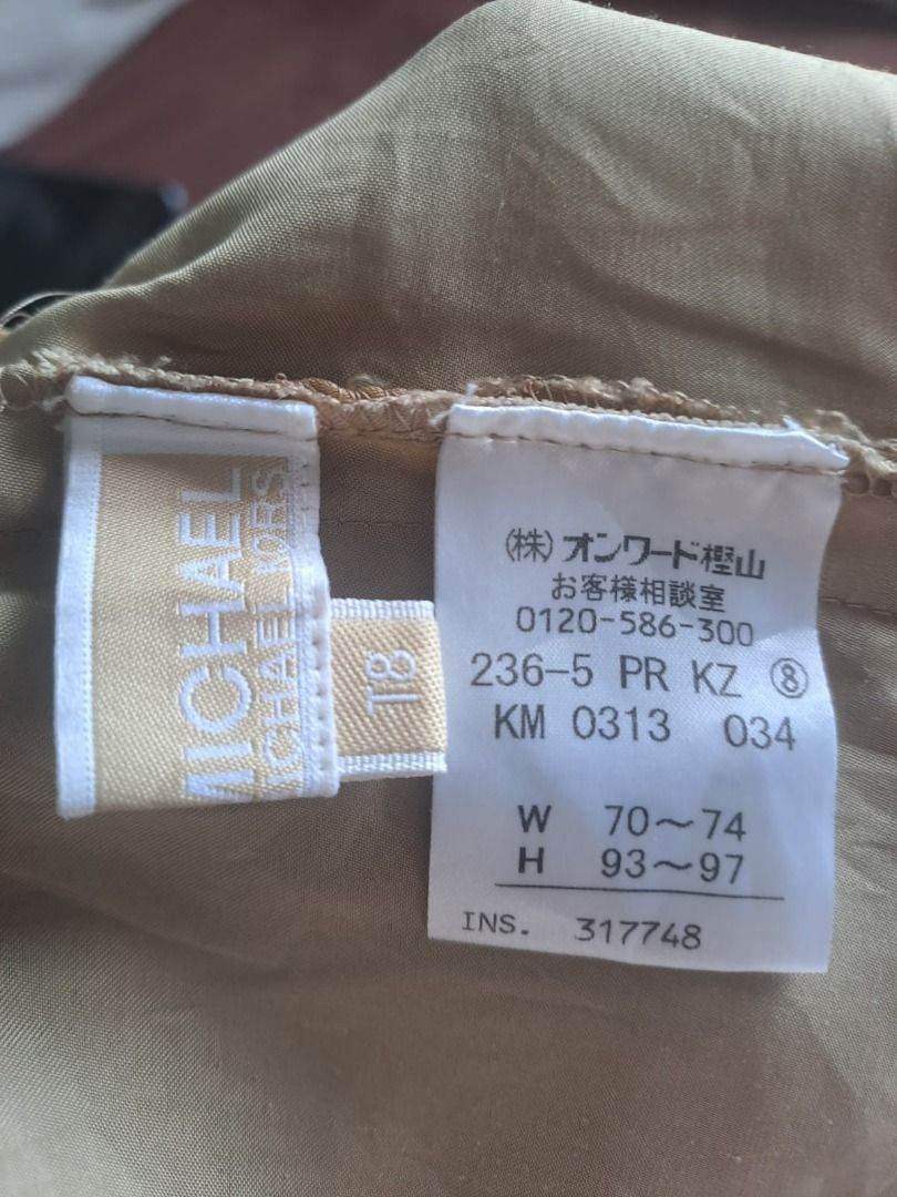 MICHAEL KORS BEIGE PANTS (Category: Other Bottoms) located in Mandaluyong City. Submitted by epicowl-c93c (Listing ID 1468099063, Image 3). Description: The image shows a pair of MICHAEL KORS khaki or beige relaxed-fit cargo or parachute-style trousers with an elasticized waistband and drawstring hems..
