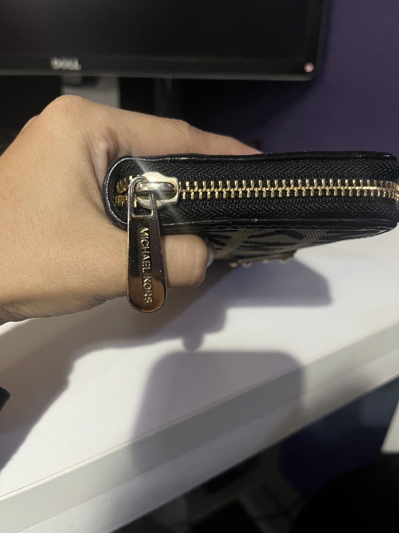 Michael Kors Black and Beige Monogram Zip-Around Wallet (Category: Luxury Bags & Wallets) located in Marikina City. Submitted by miiicloseet (Listing ID 1468208474, Image 3). Description: - Brand: Michael Kors - Design: Black and beige monogram print with black leather trim - Hardware: Gold-tone with engraved pull tab and front logo plaque - Interior: Multiple card slots, cash compartments, and central zipped coin pocket - Condition: Clean interi