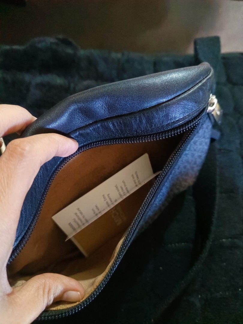 Mk original (Category: Luxury Bags & Wallets) located in Manila. Submitted by rochelleci78148 (Listing ID 1468073781, Image 3). Description: - Brand: Michael Kors - Design: Dark gray and black monogram print with silver-toned hardware - Storage: Main zipped compartment and front zipper pocket - Fit: Adjustable black fabric strap for a custom, comfortable fit - Condition: Clean interior lining with brand tag, sturdy construction - Use: Ideal for d
