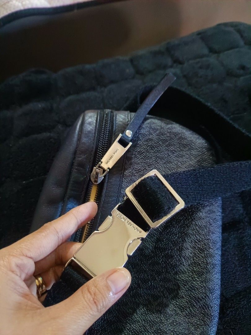Mk original (Category: Luxury Bags & Wallets) located in Manila. Submitted by rochelleci78148 (Listing ID 1468073781, Image 2). Description: - Brand: Michael Kors - Design: Dark gray and black monogram print with silver-toned hardware - Storage: Main zipped compartment and front zipper pocket - Fit: Adjustable black fabric strap for a custom, comfortable fit - Condition: Clean interior lining with brand tag, sturdy construction - Use: Ideal for d