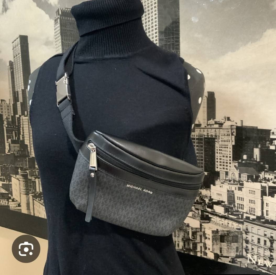 Mk original (Category: Luxury Bags & Wallets) located in Manila. Submitted by rochelleci78148 (Listing ID 1468073781, Image 1). Description: - Brand: Michael Kors - Design: Dark gray and black monogram print with silver-toned hardware - Storage: Main zipped compartment and front zipper pocket - Fit: Adjustable black fabric strap for a custom, comfortable fit - Condition: Clean interior lining with brand tag, sturdy construction - Use: Ideal for d