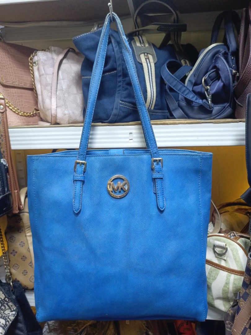 Michael Kors Blue Tote Bag (Category: Tote Bags) located in Manila. Submitted by del_thrifts03 (Listing ID 1468111317, Image 1). Description: - Authentic Michael Kors tote bag in a stunning bright blue - Premium Saffiano leather with luxurious gold-tone MK hardware - Double shoulder straps with adjustable buckle details - Spacious interior with MK monogram lining, slip pockets, and a secure zip pocket - Convenient exterior back slip pocket for ea