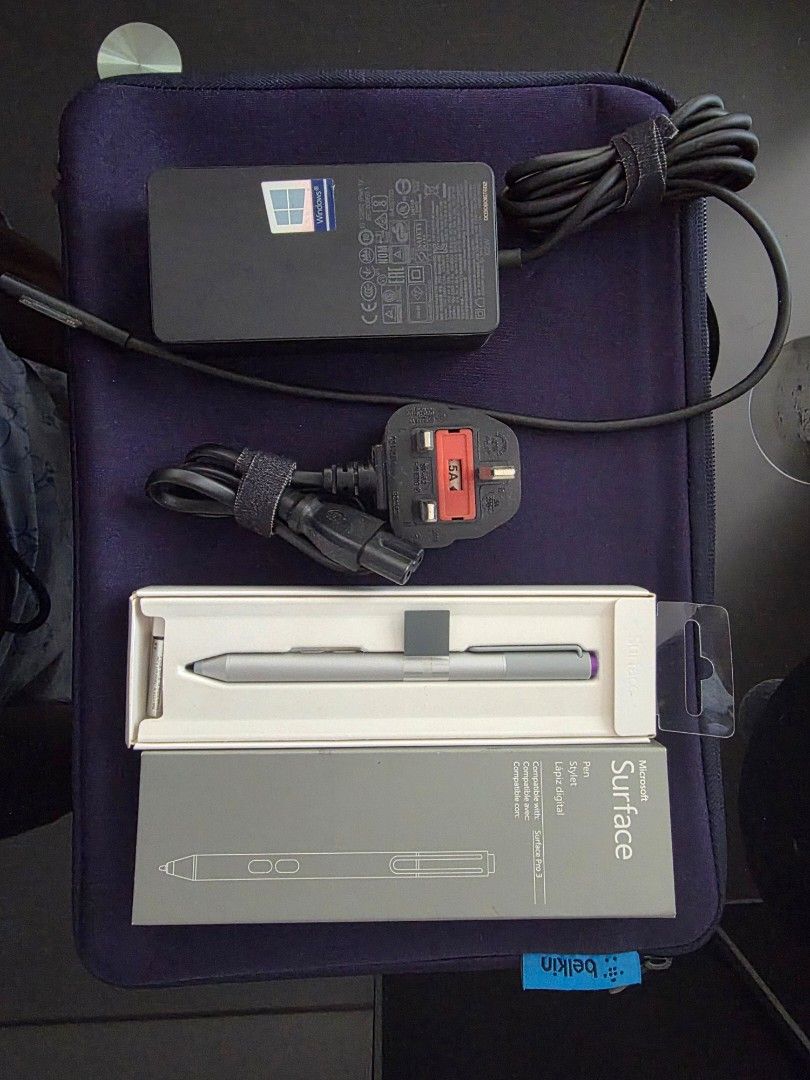 Microsoft Surface Pro 3 Pen and Power Supply (Category: Laptops & Notebooks) located in Pasay City. Submitted by rsar888 (Listing ID 1468131653, Image 2). Description: - Authentic Microsoft Surface Pro 3 stylus pen - Original power adapter with UK 3-pin power cord - Dark blue Belkin laptop sleeve included - Sold as a complete bundle (everything in photo goes together) - Ideal spare or replacement accessories.