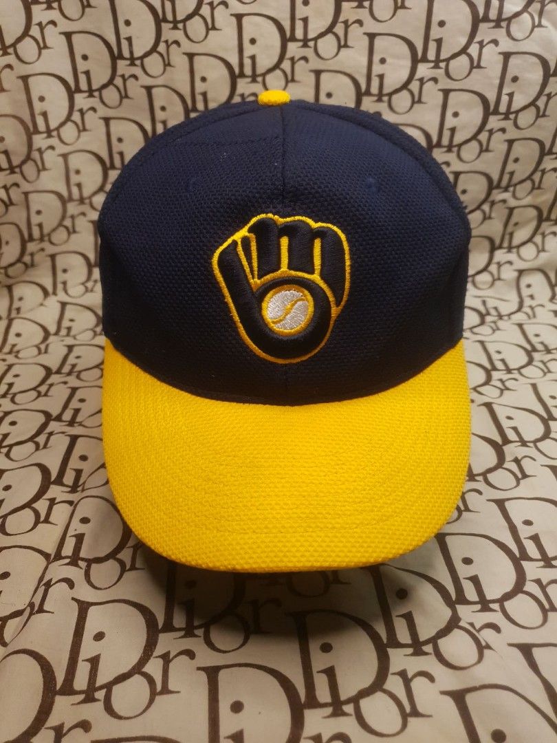MILWAUKEE BREWERS BASEBALL CAP (Category: Caps & Hats) located in San Fernando. Submitted by _jaximus (Listing ID 1468216969, Image 2). Description: Milwaukee Brewers baseball cap. Navy blue body with a yellow brim and textured mesh fabric. Classic embroidered glove logo on the front. Small KTI Country embroidery on the side panel. Blue plastic snapback closure on the back for adjustable sizing. Interior shows visible sweat stains along the inner