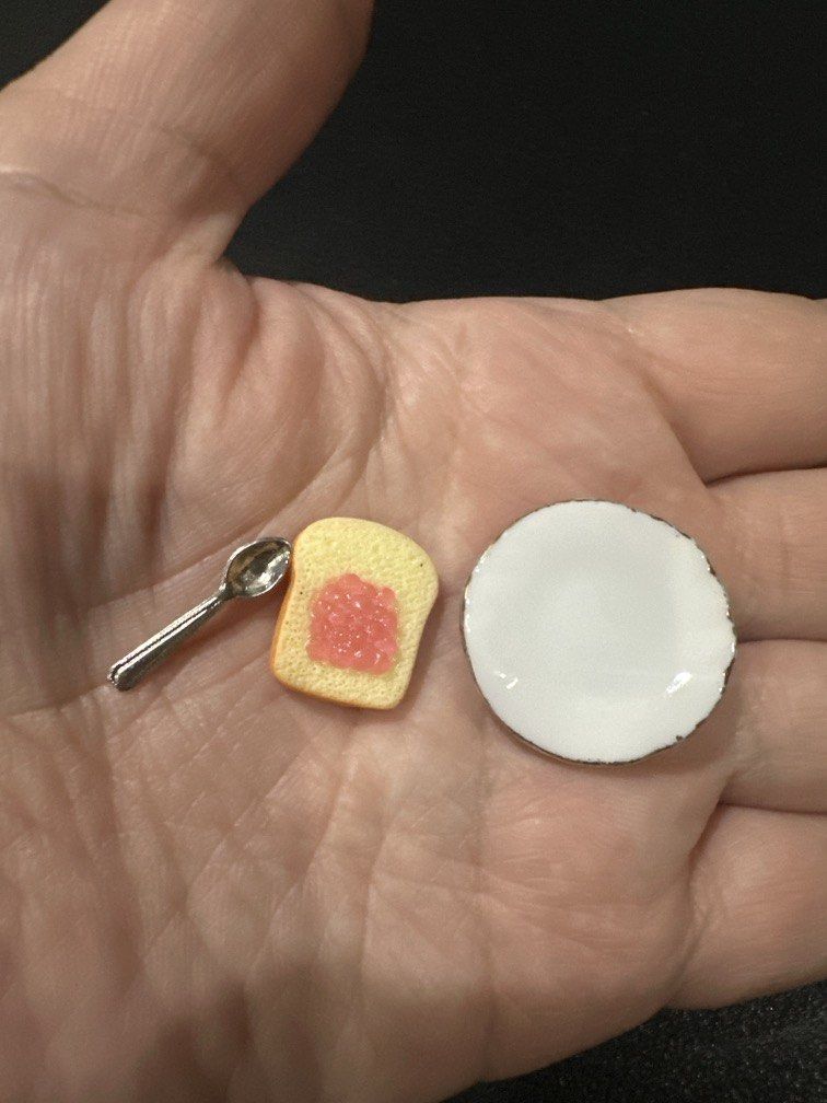 Miniature toy breakfast set (Category: Kids Toys) located in Manila. Submitted by krystalchewey_ (Listing ID 1468128656, Image 3). Description: Bnew Actual Photo Posted 150php Set ONLY TAKE ALL featuring a slice of toast with pink/red jam on a small white plate alongside a tiny spoon .