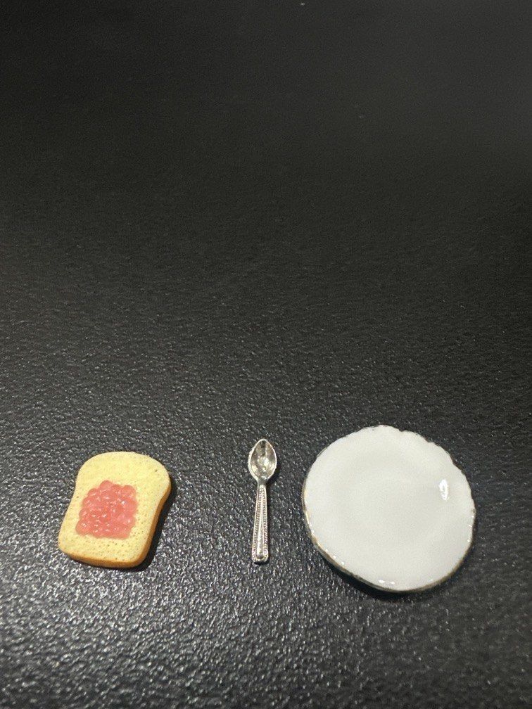 Miniature toy breakfast set (Category: Kids Toys) located in Manila. Submitted by krystalchewey_ (Listing ID 1468128656, Image 2). Description: Bnew Actual Photo Posted 150php Set ONLY TAKE ALL featuring a slice of toast with pink/red jam on a small white plate alongside a tiny spoon .