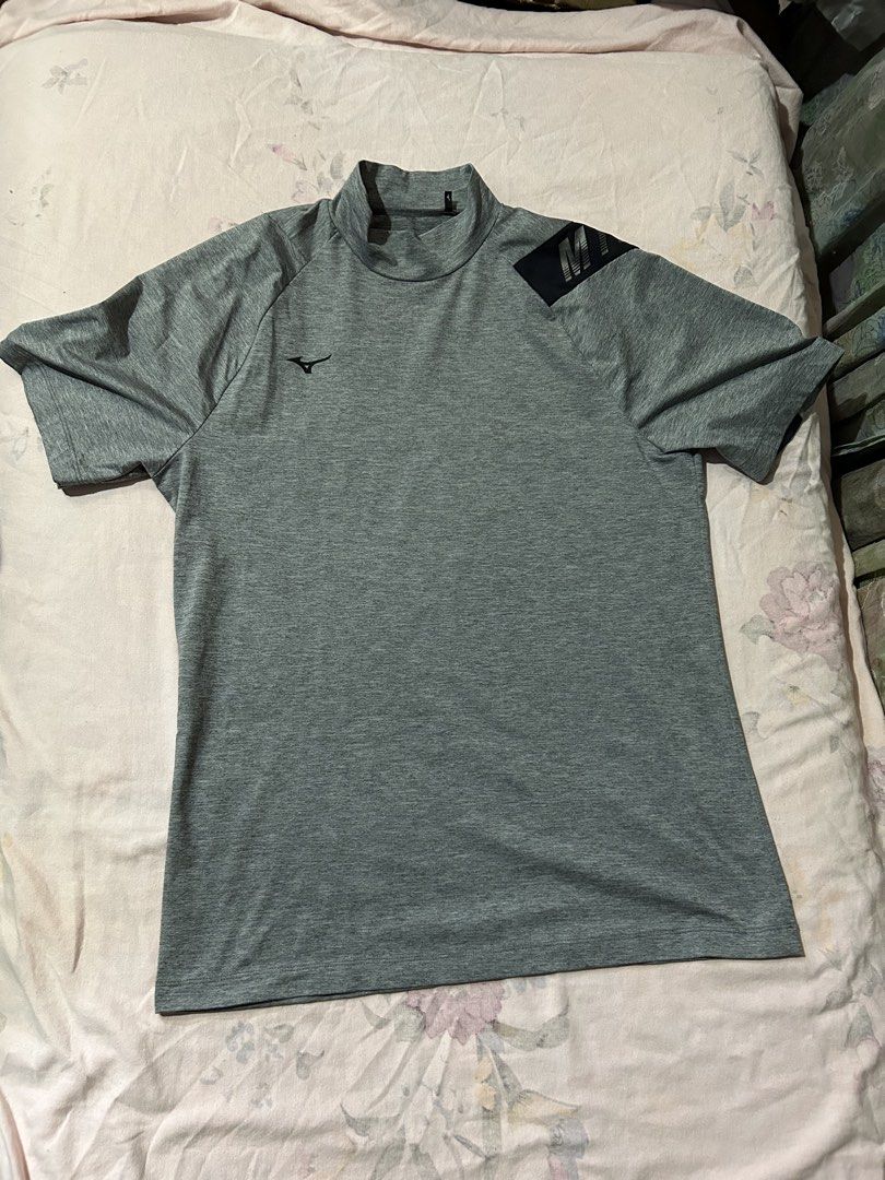 Mizuno Grey Mock Neck Athletic Shirt (Category: Tshirts & Polo Shirts ) located in Cebu City. Submitted by purephoenix-2e10a3 (Listing ID 1468091336, Image 1). Description: - Color: Grey with black accent panel on left shoulder - Style: Mock neck, short sleeve sports top - Details: Large Mizuno branding on shoulder, proper tag inside neck - Material: Lightweight athletic fabric - Condition: Clean and well-maintained - Best for: Workouts, running,